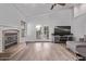 Living room featuring a fireplace, wood floors, and backyard views at 3907 E Topeka Dr, Phoenix, AZ 85050