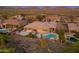 Aerial view of a home with a pool and mountain views at 41424 N Club Pointe Dr, Anthem, AZ 85086