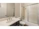Nicely updated bathroom with shower over tub, tile walls, and framed mirror at 41424 N Club Pointe Dr, Anthem, AZ 85086