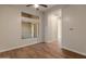 Comfortable bedroom featuring beautiful wood flooring and a large window at 41424 N Club Pointe Dr, Anthem, AZ 85086