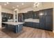 Open kitchen design with a large island, wood floors, stainless appliances and stylish cabinets at 41424 N Club Pointe Dr, Anthem, AZ 85086