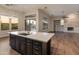 Kitchen island with sink and marble countertops at 41424 N Club Pointe Dr, Anthem, AZ 85086