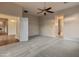 Spacious main bedroom featuring neutral carpeting, a ceiling fan, and access to the bathroom at 41424 N Club Pointe Dr, Anthem, AZ 85086