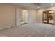 Large main bedroom with neutral carpeting and outside access to private patio at 41424 N Club Pointe Dr, Anthem, AZ 85086