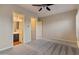 Spacious main bedroom featuring neutral carpeting and access to the main bathroom at 41424 N Club Pointe Dr, Anthem, AZ 85086