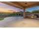 Covered patio features an outdoor kitchen and fireplace, perfect for entertaining at 41424 N Club Pointe Dr, Anthem, AZ 85086