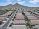 A high-angle view of a neighborhood featuring orderly street layouts, neat yards, and stunning mountain backdrops at 4148 W Dayflower Dr, San Tan Valley, AZ 85144