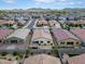 An aerial view of a backyard with a serene pond, lush landscaping, and a privacy fence at 4148 W Dayflower Dr, San Tan Valley, AZ 85144