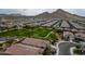 Serene aerial of a neighborhood showcasing rooftops, roads, and mountain views at 4148 W Dayflower Dr, San Tan Valley, AZ 85144