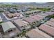 An aerial view of a neighborhood with homes featuring fenced yards and well-maintained landscaping at 4148 W Dayflower Dr, San Tan Valley, AZ 85144