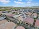 An aerial view of a neighborhood with tidy homes and landscaped yards set against a backdrop of distant mountains at 4148 W Dayflower Dr, San Tan Valley, AZ 85144
