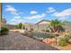 Private backyard oasis featuring a serene pond with lush landscaping and paved patio area at 4148 W Dayflower Dr, San Tan Valley, AZ 85144