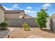 A well-kept backyard with fresh gravel, trees, brick pavers, and a sturdy block fence at 4148 W Dayflower Dr, San Tan Valley, AZ 85144