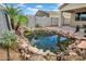 Relaxing backyard pond featuring koi fish, lush greenery, and a soothing fountain at 4148 W Dayflower Dr, San Tan Valley, AZ 85144