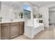 Bright bathroom with a soaking tub, dual sinks, and large mirrors at 4148 W Dayflower Dr, San Tan Valley, AZ 85144