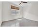 Bright bedroom with a ceiling fan, window with blinds, and tile floors at 4148 W Dayflower Dr, San Tan Valley, AZ 85144