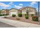 View of the front of a home featuring desert landscaping, a two car garage and tile roof at 4148 W Dayflower Dr, San Tan Valley, AZ 85144
