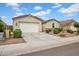 Front view of a well-maintained one story home with a two car garage and low maintenance landscaping at 4148 W Dayflower Dr, San Tan Valley, AZ 85144