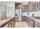 Modern kitchen with stainless steel appliances, granite countertops, and dark wood cabinets at 4148 W Dayflower Dr, San Tan Valley, AZ 85144