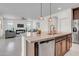 Open concept kitchen with a granite countertop island, stainless steel appliances, and a view into the living room at 4148 W Dayflower Dr, San Tan Valley, AZ 85144
