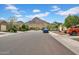 A quiet street lined with well-kept homes, manicured yards, and scenic mountain views at 4148 W Dayflower Dr, San Tan Valley, AZ 85144
