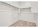 Walk-in closet featuring carpeted floors, white walls, and shelving at 4148 W Dayflower Dr, San Tan Valley, AZ 85144
