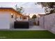 This home's backyard boasts a hot tub, lush artificial turf, and block wall for privacy at 4527 N 12Th Ave, Phoenix, AZ 85013