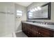 The bathroom features granite countertops, dark wood cabinets, and a sleek glass-enclosed shower with white tile at 4527 N 12Th Ave, Phoenix, AZ 85013