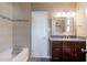 Bathroom featuring granite countertops, tiled walls, a spacious tub, and a decorative mirror at 4527 N 12Th Ave, Phoenix, AZ 85013