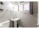 Bathroom featuring a pedestal sink, a framed mirror, and modern fixtures at 4527 N 12Th Ave, Phoenix, AZ 85013