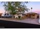 Charming single-story home featuring a covered porch and carport, complemented by mature landscaping and RV parking at 4527 N 12Th Ave, Phoenix, AZ 85013
