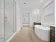 Light and airy bathroom with glass shower, soaking tub, and double sink vanity at 4795 W Hunter Trl, San Tan Valley, AZ 85144