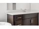 Bathroom vanity with white countertop, dark wood cabinets and stainless steel hardware at 4795 W Hunter Trl, San Tan Valley, AZ 85144