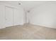 A large, empty bedroom with neutral carpet and a closet with sliding doors at 4795 W Hunter Trl, San Tan Valley, AZ 85144