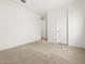 A bright bedroom features neutral carpet and white walls at 4795 W Hunter Trl, San Tan Valley, AZ 85144