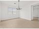 Minimalist dining room with tile flooring and modern chandelier at 4795 W Hunter Trl, San Tan Valley, AZ 85144