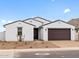 Charming single-story home featuring a brick driveway, a two-car garage and neutral colored stucco at 4795 W Hunter Trl, San Tan Valley, AZ 85144