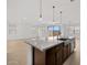 Open concept kitchen with granite countertops, tile floors, leading to living area at 4795 W Hunter Trl, San Tan Valley, AZ 85144