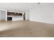 Open living room area with a view of a modern kitchen and stainless steel appliances at 4795 W Hunter Trl, San Tan Valley, AZ 85144