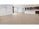 Open living room area with a view of a modern kitchen, complete with granite countertops at 4795 W Hunter Trl, San Tan Valley, AZ 85144