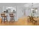 Bright dining area with a glass table and modern chairs adjacent to the kitchen and living spaces at 5104 N 32Nd St # 311, Phoenix, AZ 85018