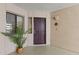 Cozy entrance features a dark wood door, neutral textured walls, and a small window with a decorative potted plant at 5104 N 32Nd St # 311, Phoenix, AZ 85018