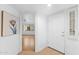 Bright entryway featuring white walls, light tile floors, and a view into a living area with wood floors at 5104 N 32Nd St # 311, Phoenix, AZ 85018