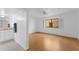 Open bedroom with attached bath featuring wood floors, an exterior window, and neutral paint at 5104 N 32Nd St # 311, Phoenix, AZ 85018