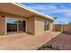 A tranquil backyard with brick pavers, sliding glass doors, and mature landscaping at 5316 S Palm Dr, Tempe, AZ 85283