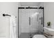 A contemporary bathroom featuring black framed shower, subway tiles, and black and white floors at 5316 S Palm Dr, Tempe, AZ 85283