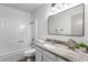 Bathroom featuring updated vanity, large mirror, shower and tub with white tile surround at 5316 S Palm Dr, Tempe, AZ 85283