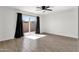Spacious bedroom with sliding glass door, modern fan, and wood-look tile floors at 5316 S Palm Dr, Tempe, AZ 85283