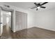 An open bedroom with wood-style floors, and a ceiling fan with closet at 5316 S Palm Dr, Tempe, AZ 85283