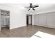 A bright bedroom with tiled floors, a ceiling fan, and a door to the bathroom at 5316 S Palm Dr, Tempe, AZ 85283